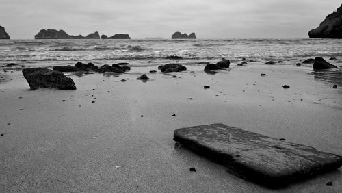Rocks on beach against sky