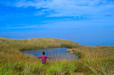 Rear view of woman relaxing on grass
