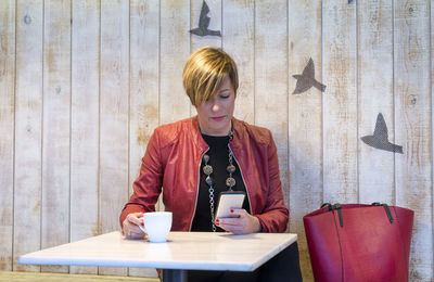 Full length of a woman with coffee cup