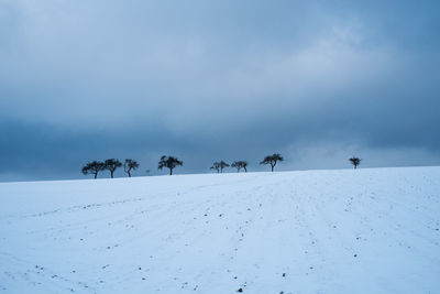 Scenic view of snow covered landscape against sky