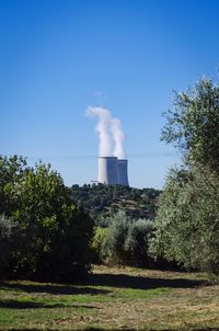 View of factory against blue sky