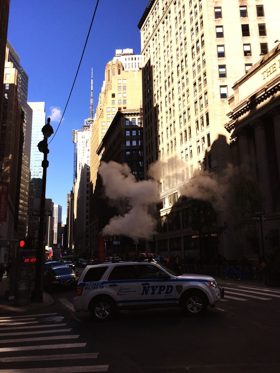 CARS ON CITY STREET AGAINST BUILDINGS