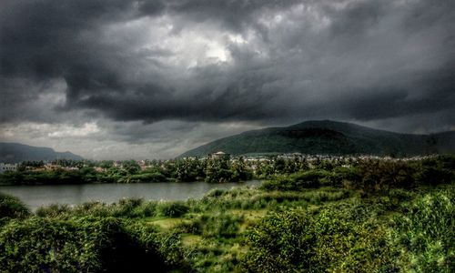 Scenic view of field against cloudy sky