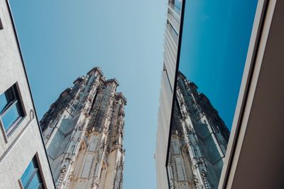 Low angle view of buildings against clear blue sky