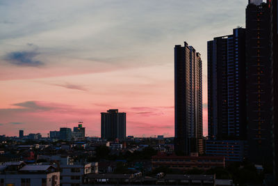 Modern buildings against romantic sky at sunset