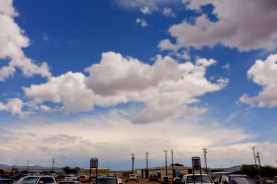 View of cityscape against cloudy sky