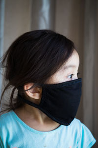 Girl wearing mask at home