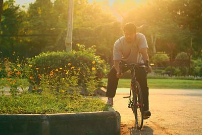 Man riding bicycle on plants