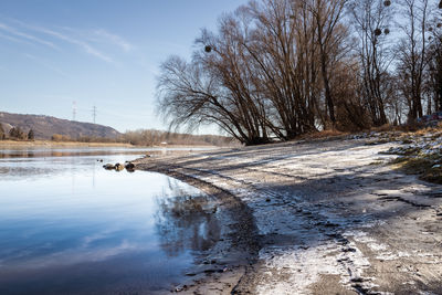 Scenic view of frozen lake against sky during winter