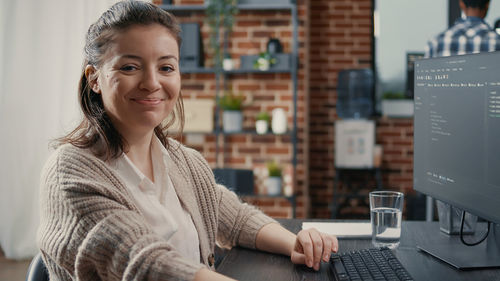 Portrait of smiling computer programmer at office