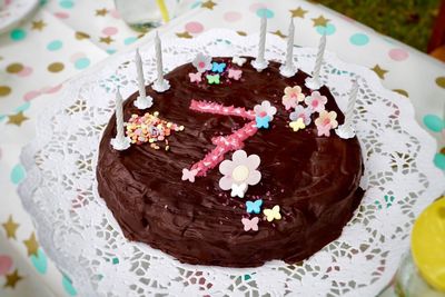 High angle view of chocolate cake on table for seventh birthday 