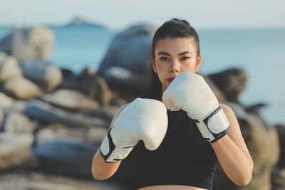 Portrait of young woman exercising at beach