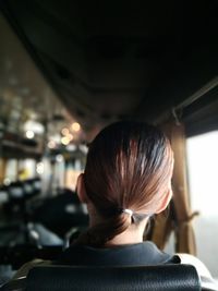 Rear view of woman in bus