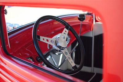 Close-up of steering wheel seen through window