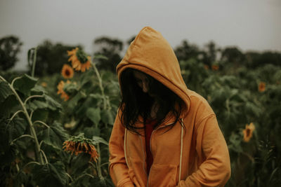 Young woman standing at sunflower farm