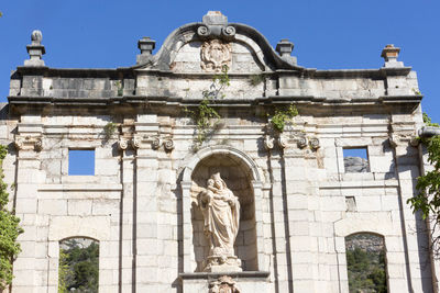 Low angle view of statue against building