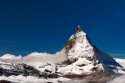 Scenic view of snow covered mountains against sky