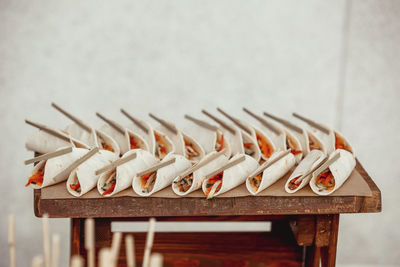 Close-up of objects on table against wall