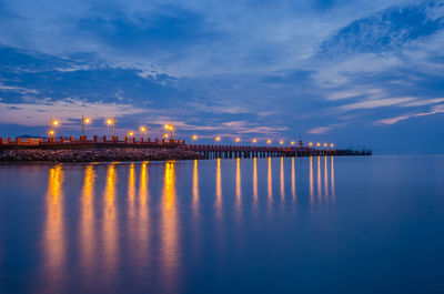 Illuminated pier at dusk