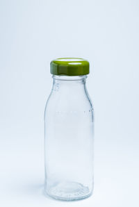 Close-up of wineglass against white background