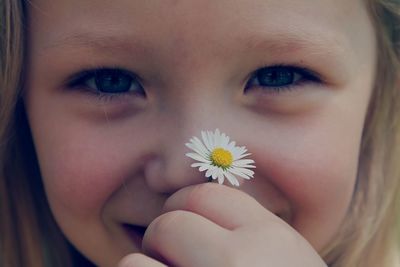 Close-up of woman holding flowers