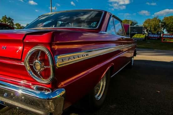 transportation, mode of transport, land vehicle, car, travel, tree, street, headlight, road, stationary, on the move, red, sky, outdoors, parking, vehicle, vintage car, no people, part of, speed