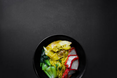 High angle view of food in bowl against black background