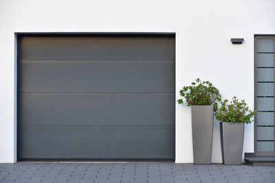 Modern gray garage, next to the scandinavian-style house