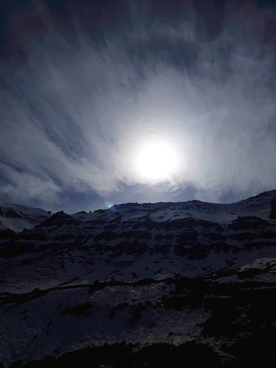 SCENIC VIEW OF SNOWCAPPED MOUNTAINS AGAINST BRIGHT SUN