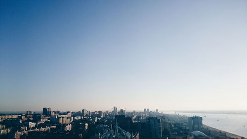 Cityscape against clear blue sky