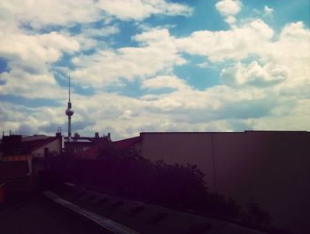 Buildings against cloudy sky