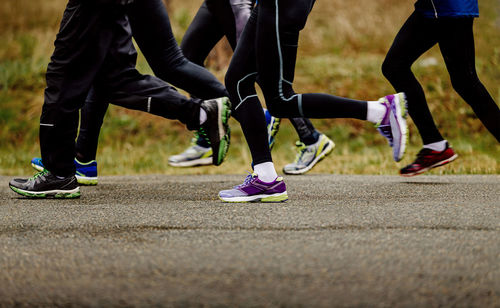 Low section of people walking on road