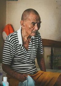 Senior man standing at home
