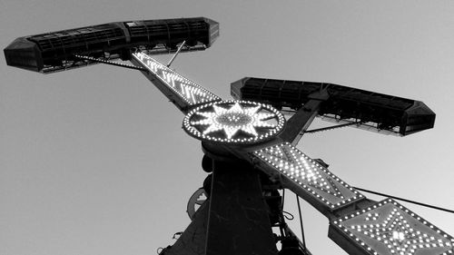 Low angle view of illuminated ferris wheel against clear sky