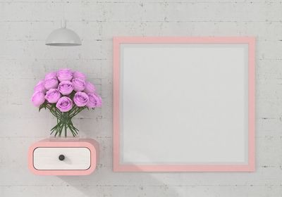 Close-up of pink flower on white wall