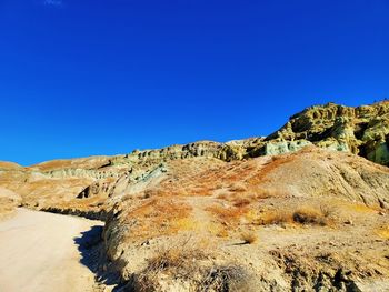 Scenic view of mountains against clear blue sky
