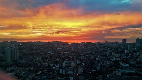 High angle view of city against cloudy sky