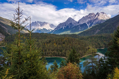 Scenic view of lake and mountains against sky