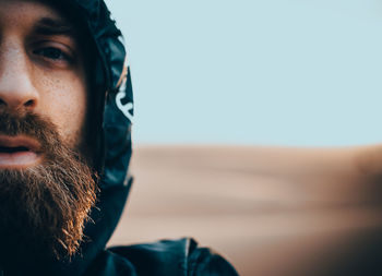 Close-up portrait of man against clear sky