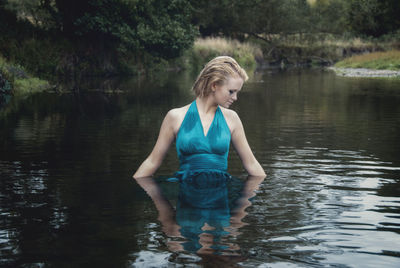 Young woman standing in lake