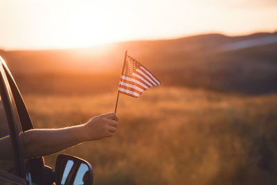 Cropped hand holding american flag