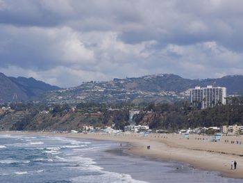 Panoramic view of beach and buildings against sky