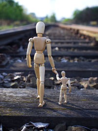 Close-up of figurines on railroad track