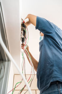 Technician repairing air conditioner on the wall