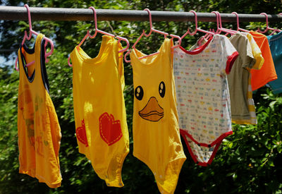 Body suit of baby colorful on hanger rack dry in the sun