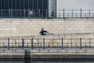 Man riding bicycle on wall