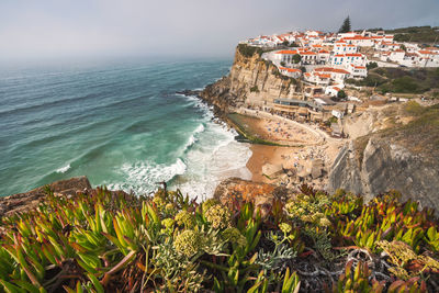 High angle view of sea and buildings against sky