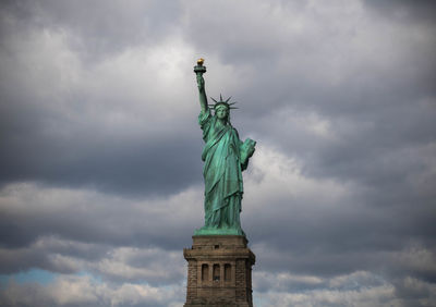 Low angle view of statue against cloudy sky