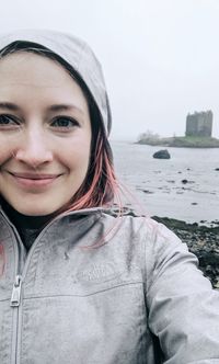 Portrait of smiling young woman at beach