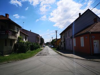 Street amidst buildings against sky